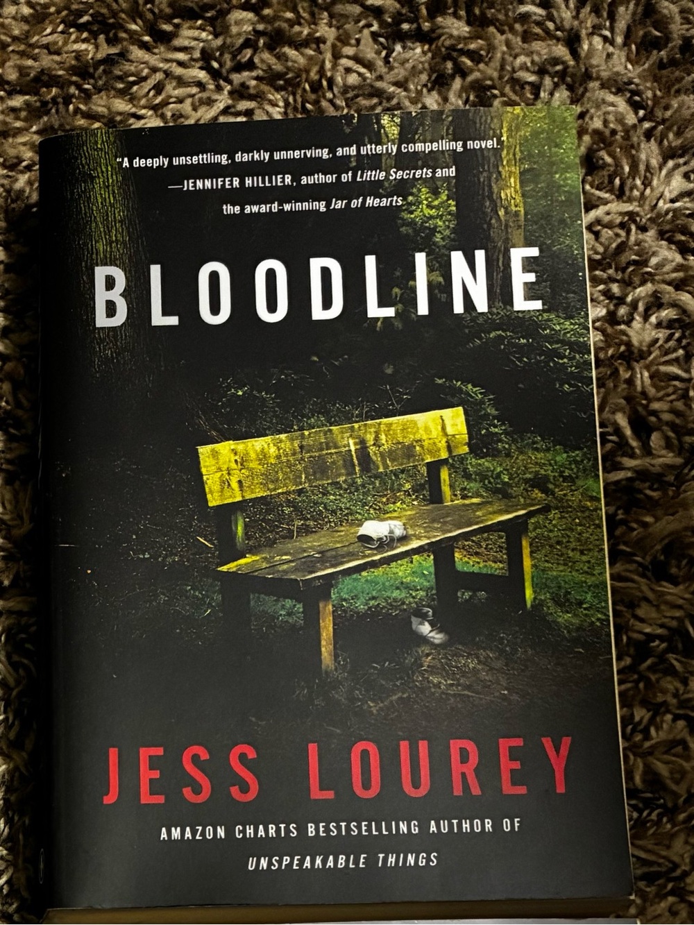 Jess Lourey Bloodline — Thriller Novel in Black and Yellow Cover